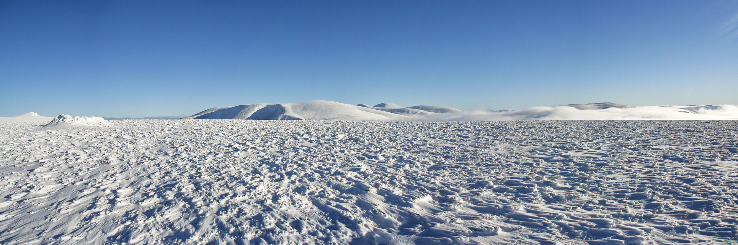 Winter panorama on Sgor Gaoith and distant Braeriach from Carn Ban Mor
